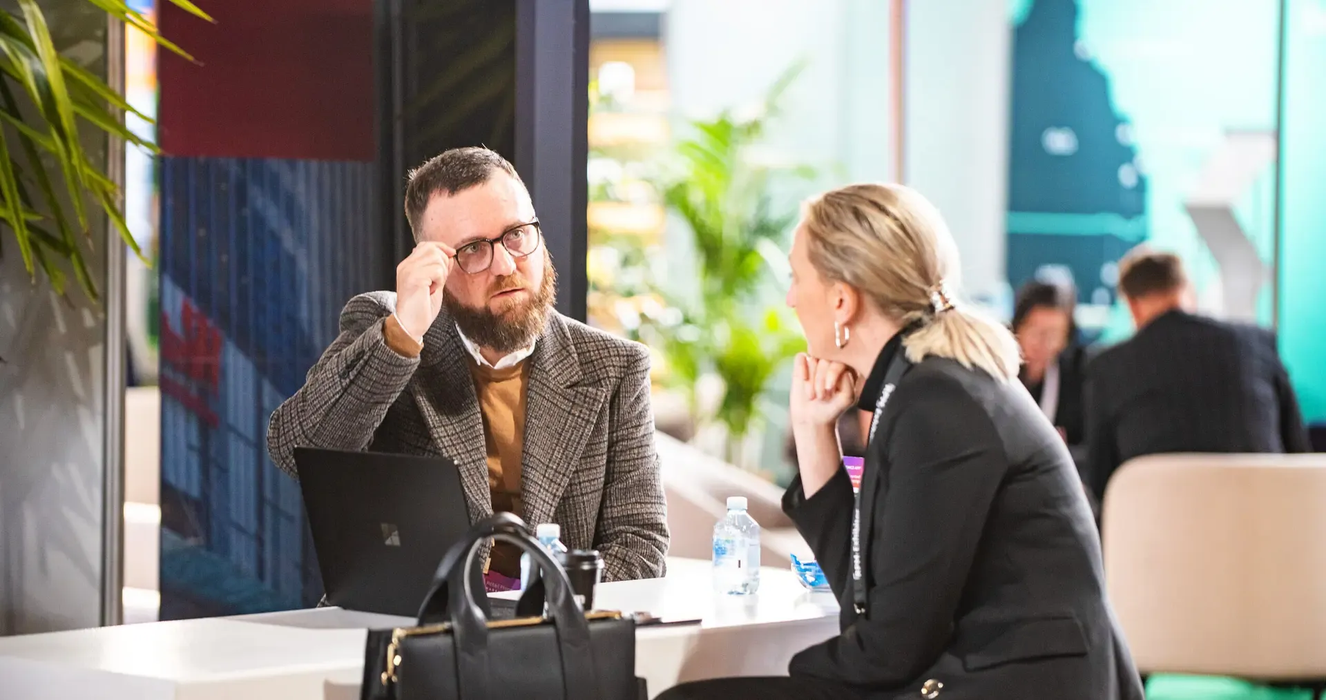Two people at a meeting table, close