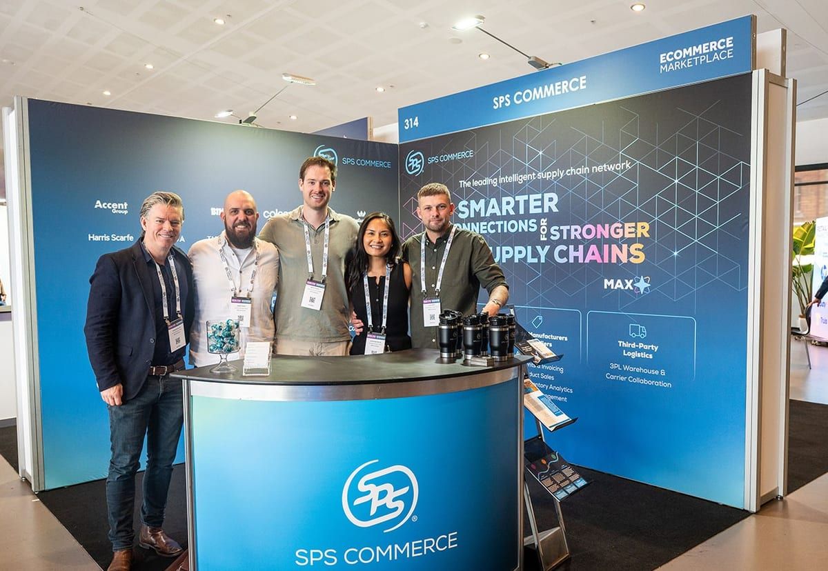 The SPS Commerce team standing together at their stand