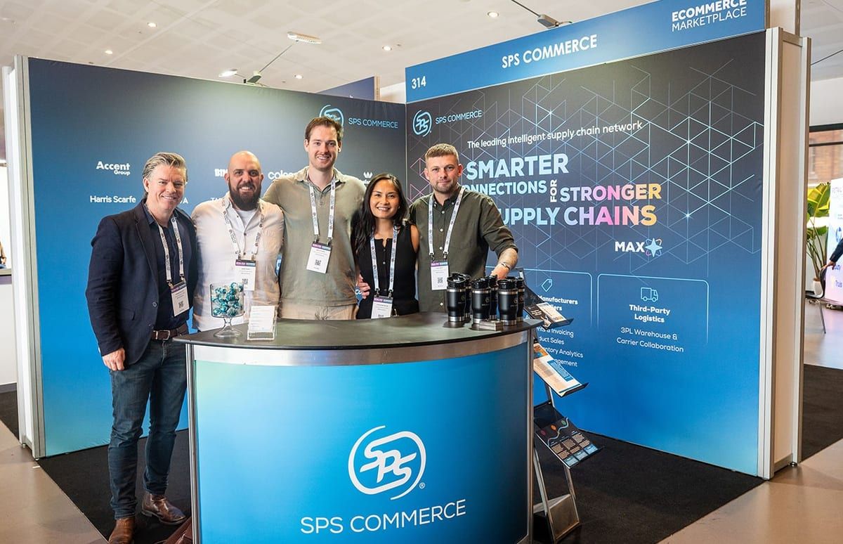 The SPS Commerce team standing together at their stand