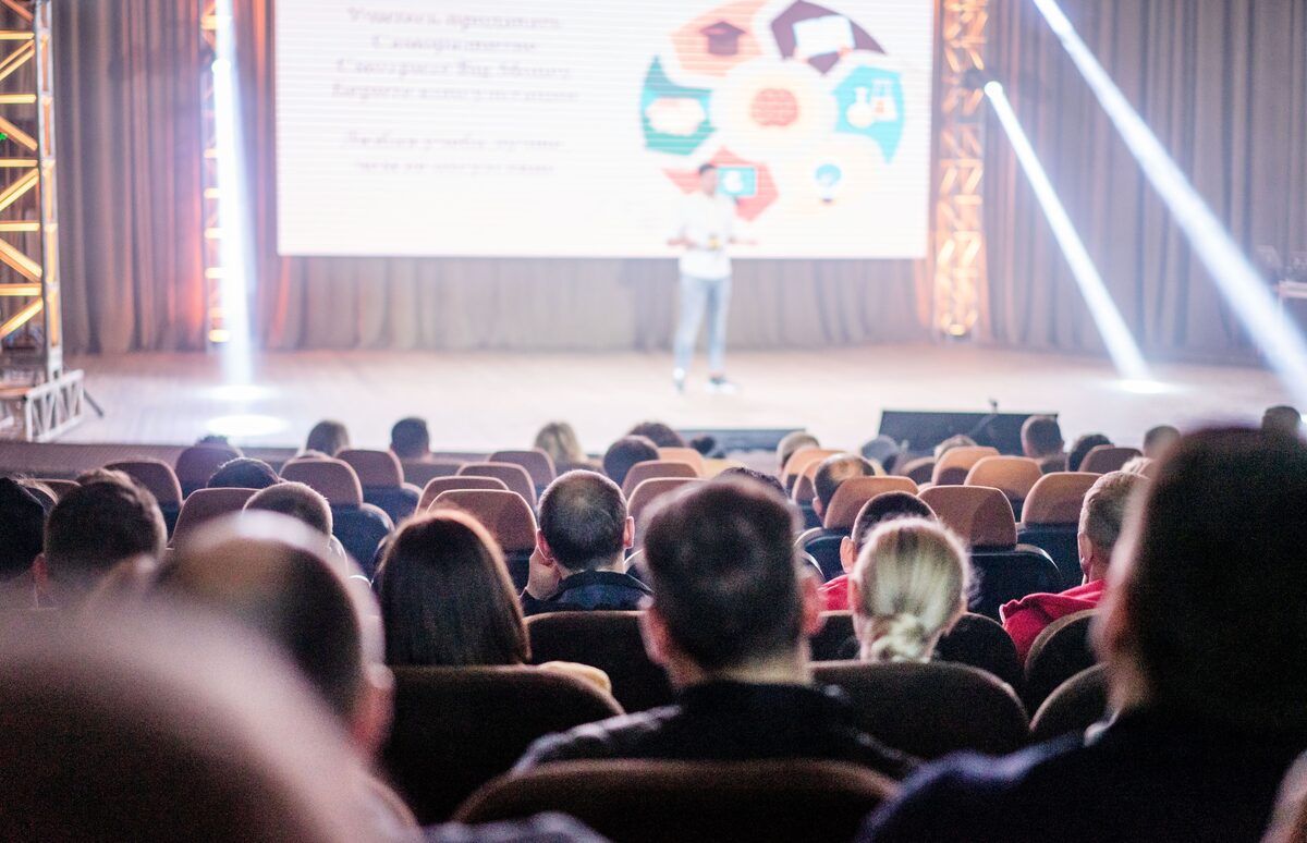 A panel discussion under stage lighting