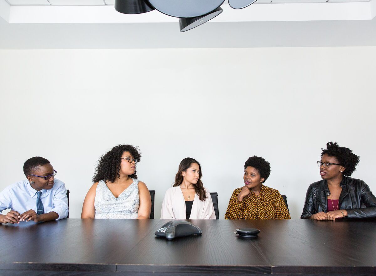 A diverse group of professionals in conversation around a table