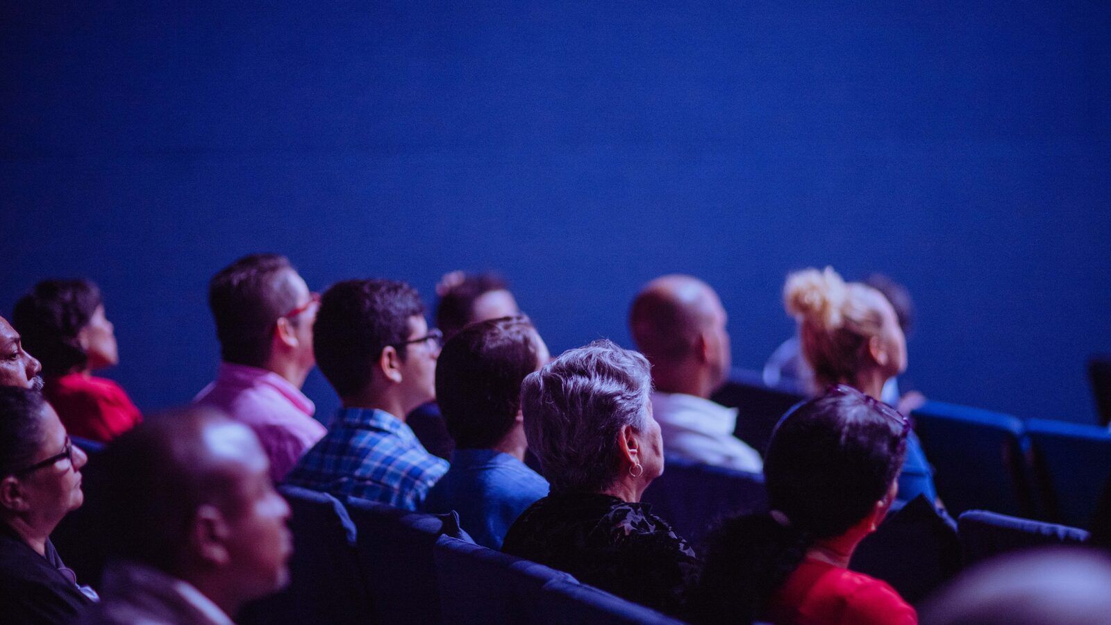 An audience watching a conference session at a technology event