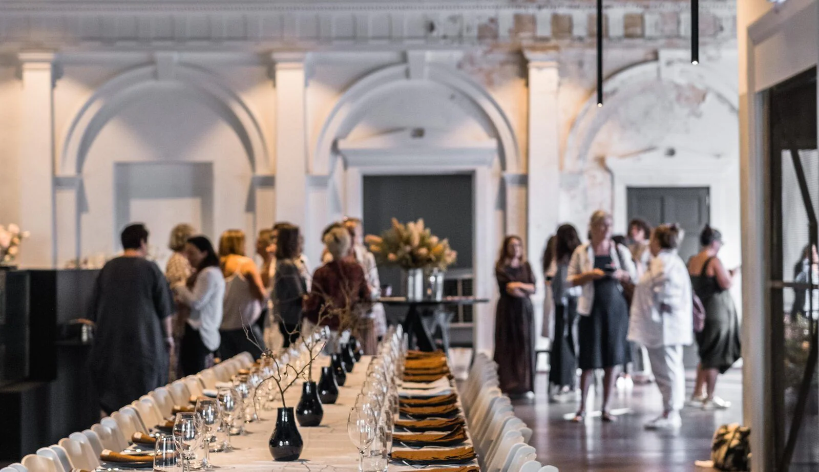 A long table set for an intimate executive dinner in a heritage venue