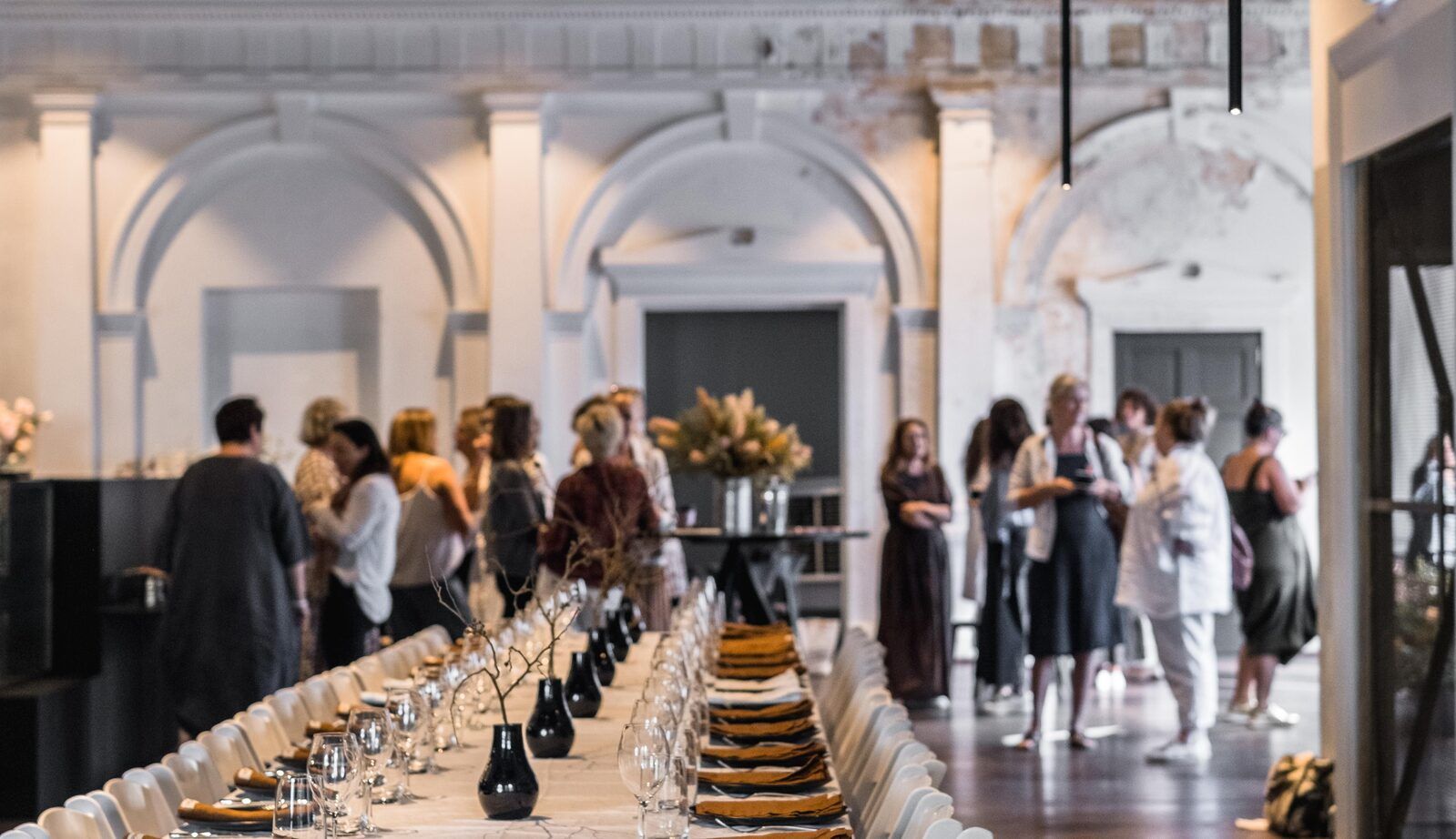 A long table set for an intimate executive dinner in a heritage venue