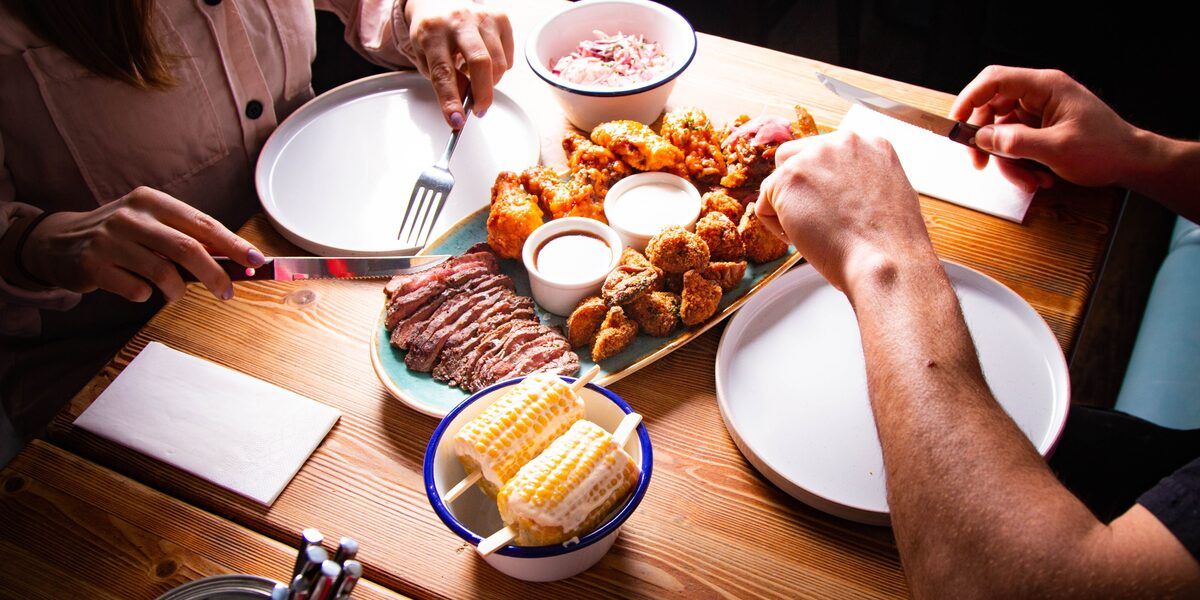 Shared plates of food being served at a conference lunch table
