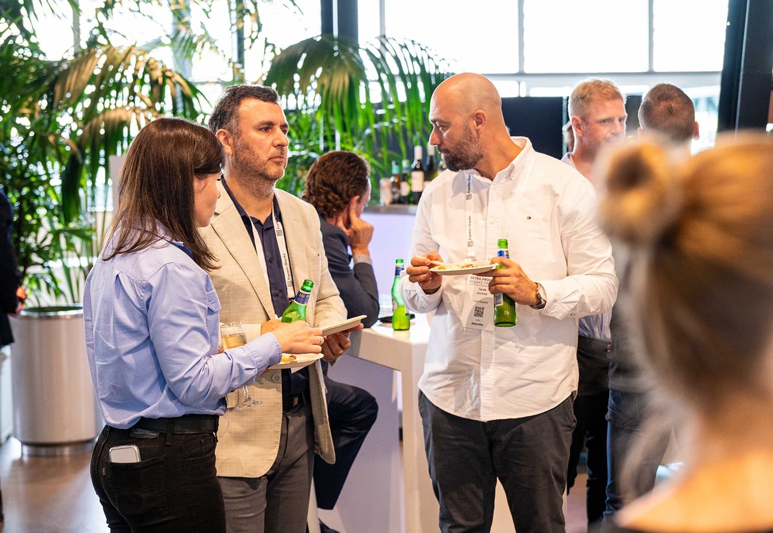 Guests chatting over drinks and food at the networking function