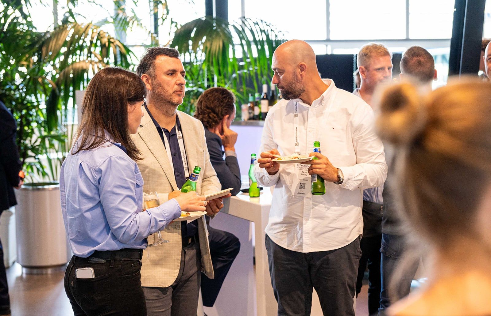 Guests chatting over drinks and food at the networking function