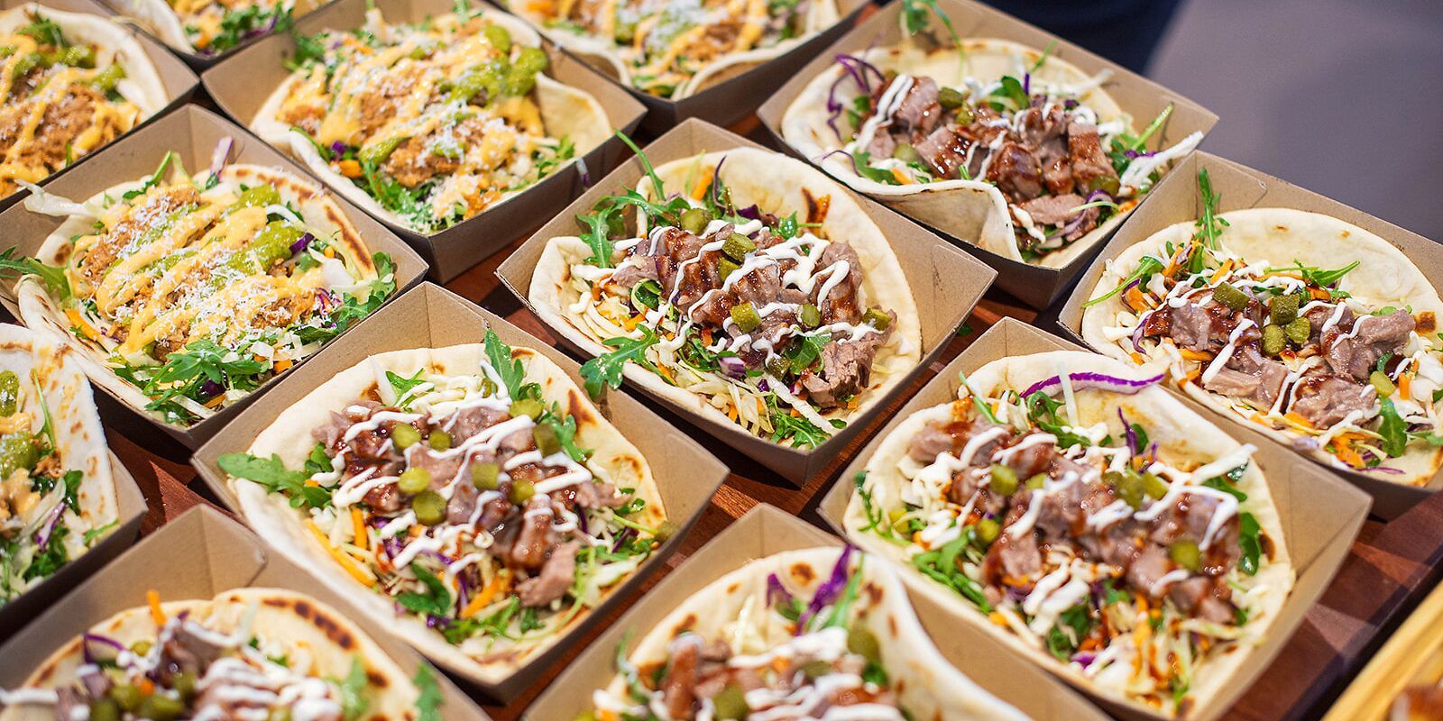Rows of filled flatbreads served in paper boats at lunch