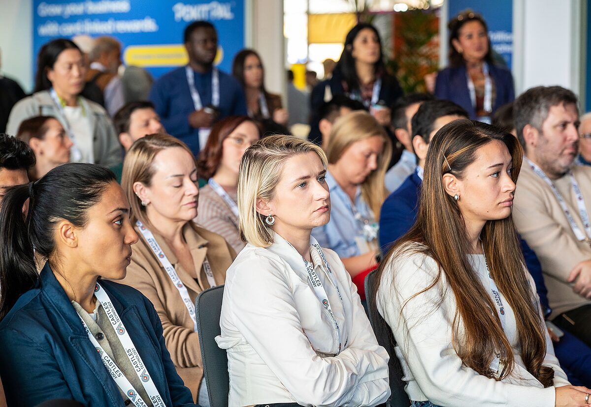 An audience seated and listening closely during a conference session