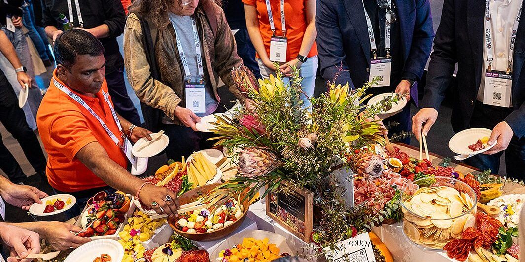 Attendees helping themselves to a grazing table at the networking session