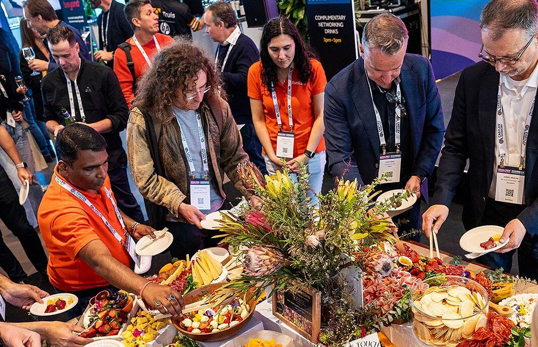 Visitors gathered around a native flower display and grazing platter at the networking drinks