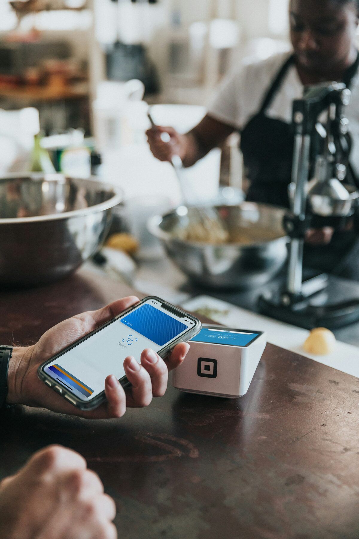 A smartphone held near a contactless payment terminal